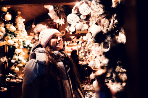 Handicraft vendor at Altwiener Christkindlmarkt selling traditional Austrian items.