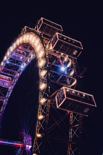 Festive light decorations at Wintermarkt Prater with Wiener Riesenrad landmark.