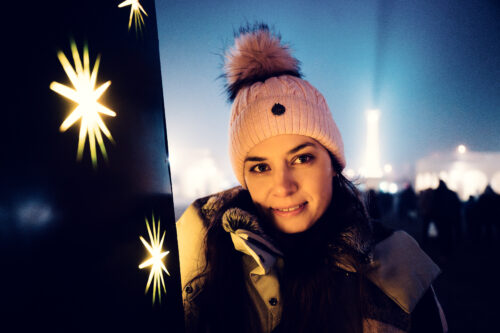 Festive lights and decorations at Christmas market in front of UNESCO World Heritage Schönbrunn Palace.