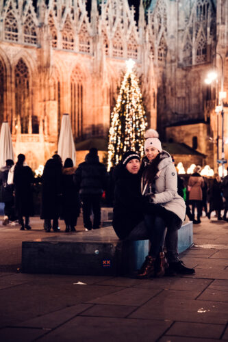 Festive lights and decorations at Christmas market on Stephansplatz with Gothic cathedral architecture in background.