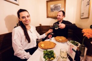 Adriana and Mario with oversized Wiener Schnitzel at Figlmüller Wollzeile Vienna.