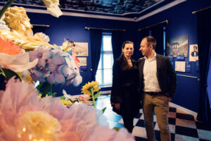 Adriana and Mario exploring a blue exhibition room at House of Strauss.