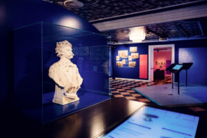 Marble bust of Johann Strauss II in a glass vitrine at House of Strauss.