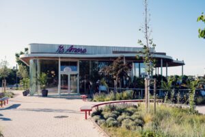 The glass-fronted It's Amore restaurant with its neon sign at Copa Beach.