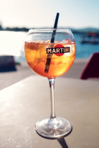 A chilled orange spritz in a glass on a sunlit Copa Beach table.
