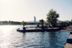 A small jetty peninsula on the Neue Donau with the Millennium Tower beyond.