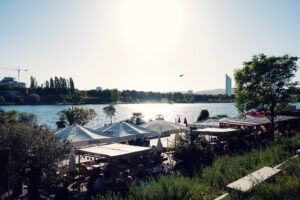Copa Beach bar terraces and parasols along the Neue Donau below the Millennium Tower.
