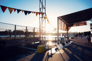 Colorful bunting over the Copa Beach promenade and beach courts at golden hour.