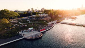 Aerial view of the curving Copa Beach promenade and park along the Neue Donau.