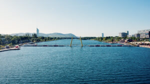 Calm Neue Donau stretching toward the Vienna Woods hills near Ponte Cagrana.
