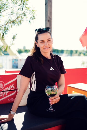 Adriana enjoying a wine spritzer at a Copa Beach bar by the water.