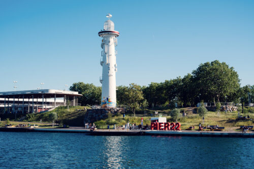 The white lighthouse beside the Pier 22 sign on the Copa Beach waterfront.