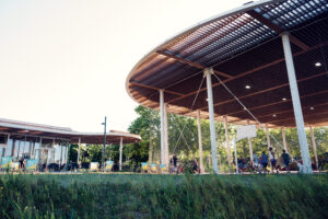 The sweeping round wooden canopy of the Copa Beach pavilion above seated guests.