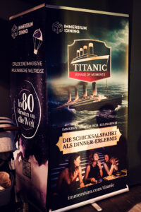 Promotional rollup banner for the Immersium Dining Titanic experience.