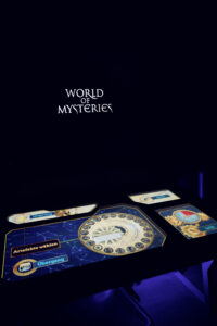 Interactive touchscreen table in a dark room with a glowing artifact-selection interface.